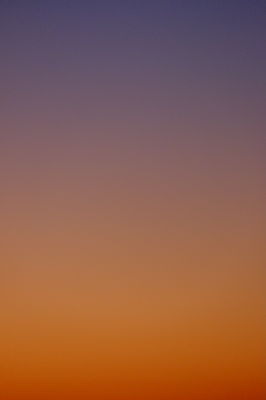 An orange sky, blending into purple as the sun sets.