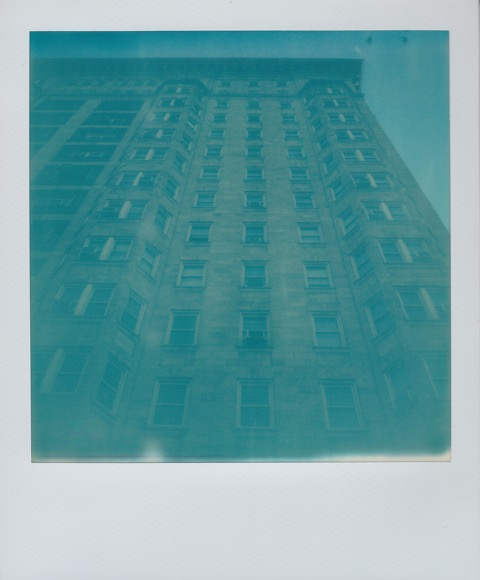 A color Polaroid photograph large brownstone apartment building. Photo taken in Philadelphia, Pennsylvania, USA.