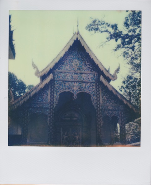 A color Polaroid photograph of a Thai temple entrance. Photo taken in Bangkok, Thailand.